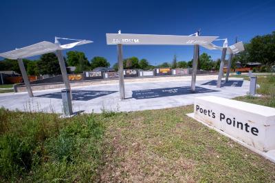 14 works on tile (7 poems and 7 artworks) on an art wall and 3 shade structures within a pocket park