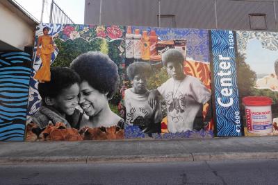 Large-scale polytab mural with references to the revolutionary spirit of the 60s and 70s and local street names of the historic east side. Each end spotlights a local east side leader. Lots of pattern work and symbolic water imagery. 