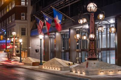 2 mixed media sculptures. Pecos red concrete forms the central lampposts. These are surrounded by bronze and steel swirling vines. A series of yucca blossom lanterns and bronze butterflies adorn the sculptures.